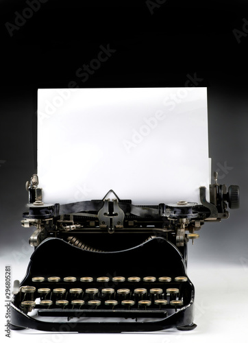 Antique Typewritter with blank paper for your type or text. . photo