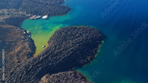Aerial drone photo of black volcanic crater turning sea to green © aerial-drone
