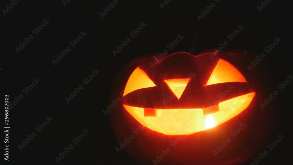 Halloween pumpkin head jack lantern with candles on a black background. Halloween holidays art design, holiday Halloween pumpkin head jack lantern with candles on a black background. Halloween holidays art design, holiday