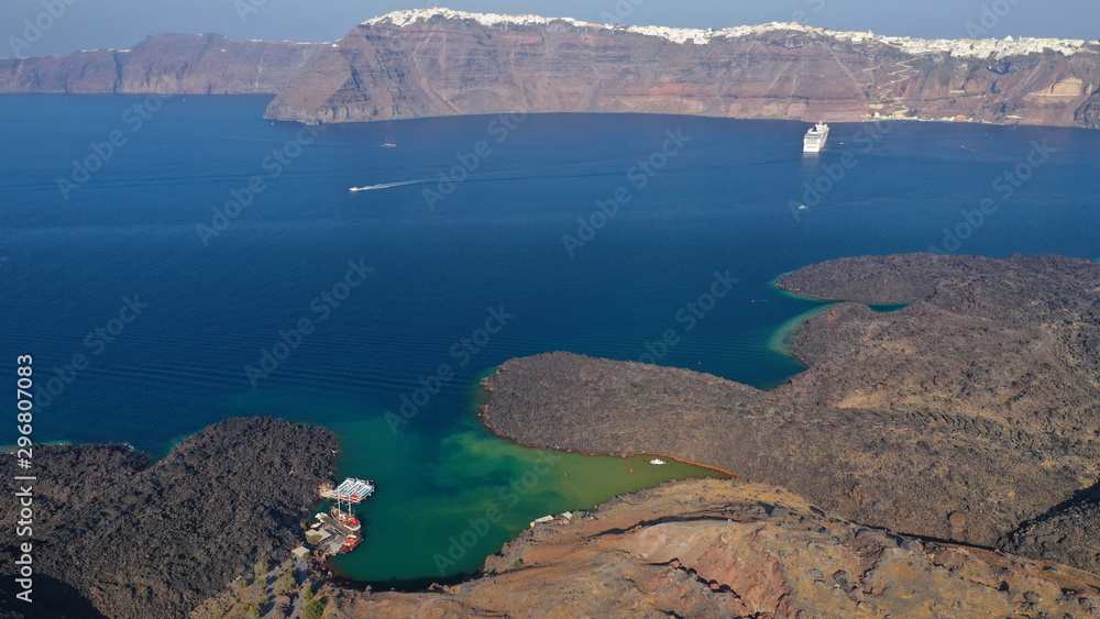 Aerial drone top down photo of iconic main Crater of Santorini volcanic island called Kameni visited by tourist boats, Cyclades, Greece