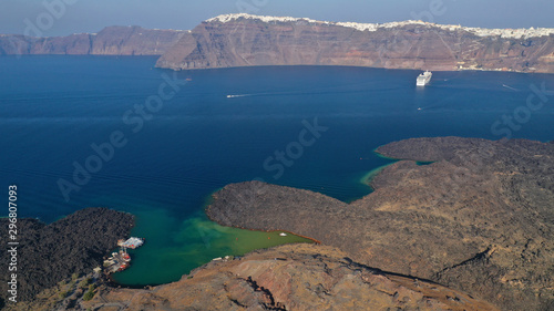 Aerial drone top down photo of iconic main Crater of Santorini volcanic island called Kameni visited by tourist boats, Cyclades, Greece