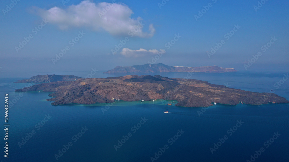 Aerial drone top down photo of iconic main Crater of Santorini volcanic island called Kameni visited by tourist boats, Cyclades, Greece Aerial drone top down photo of iconic main Crater of Santorini volcanic island called Kameni visited by tourist boats, Cyclades, Greece