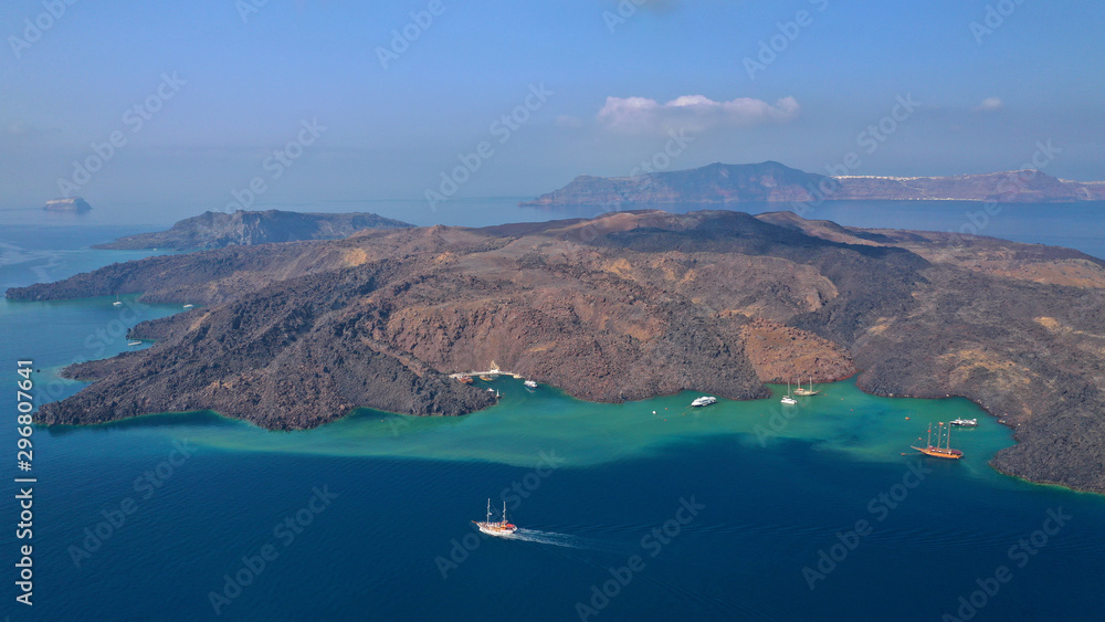 Obraz premium Aerial drone top down photo of iconic main Crater of Santorini volcanic island called Kameni visited by tourist boats, Cyclades, Greece