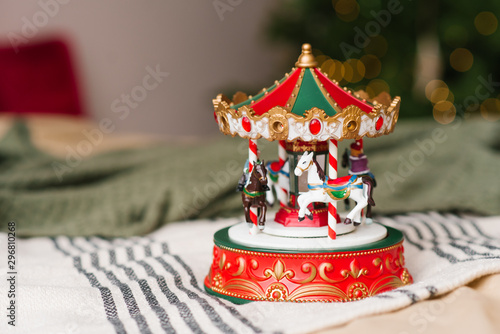 Red and white carousel toy on the background of Christmas lights