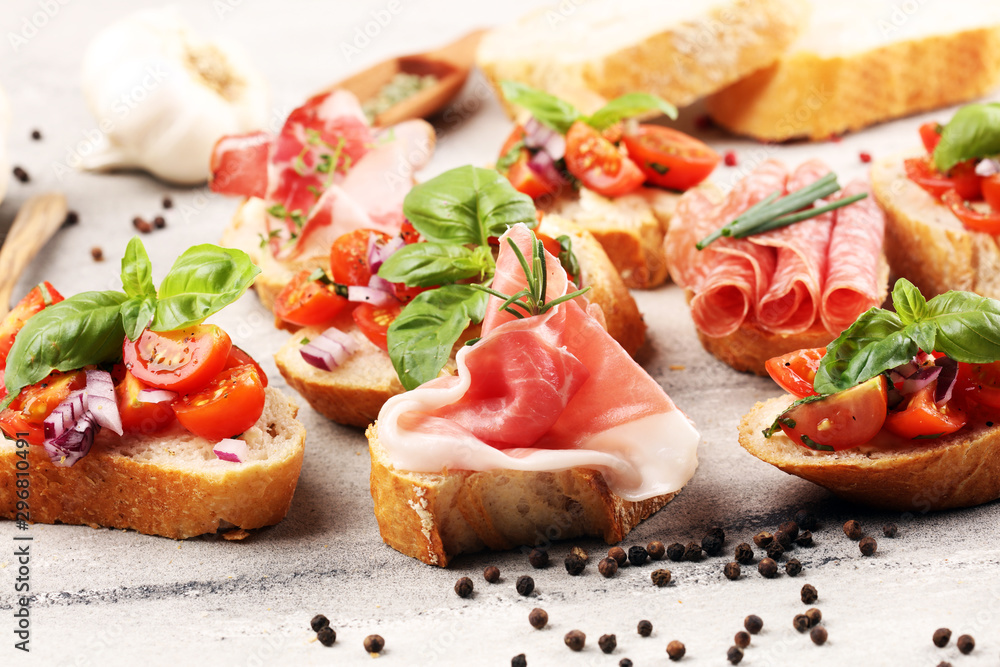 Assorted bruschetta with various toppings. Appetizing bruschetta or crudo crostini. Variety of small sandwiches. Mix bruschetta on table