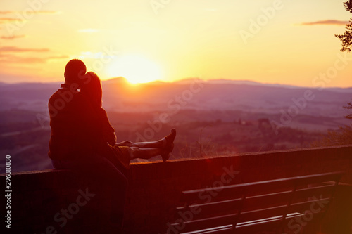 romantic man and woman enjoying together on romantic sunset.