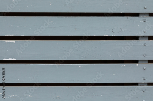 A bit shabby grey painted wooden wall with gaps photo