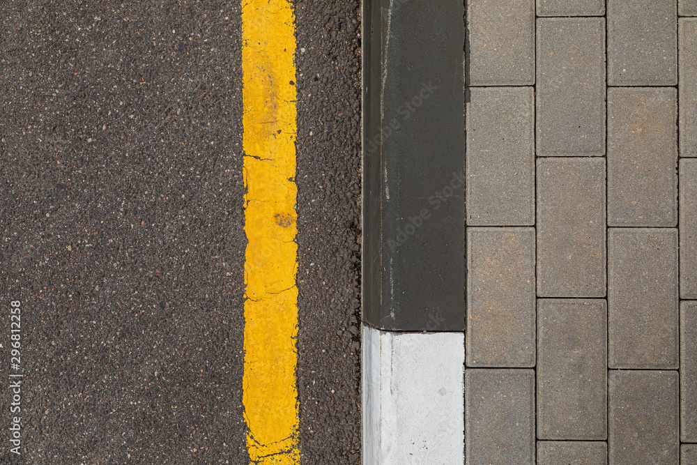 Fototapeta premium Yellow line prohibiting stop and parking for vehicles along trimming