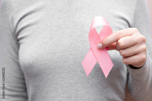 Wallpaper Mural Girl hands holding pink breast cancer awareness ribbon on gray background. Concept healthcare and medicine beauty Torontodigital.ca