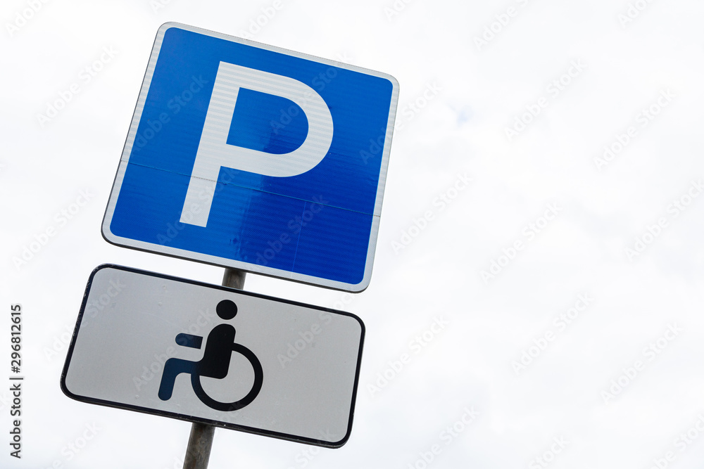Blue roadsign Disabled bay against white sky