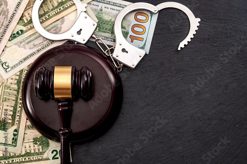 Obraz na płótnie Bail bond system, bailing out of jail and innocent until proven guilty conceptual idea with judge wooden gavel, dollar banknotes and handcuffs with copy space w salonie
