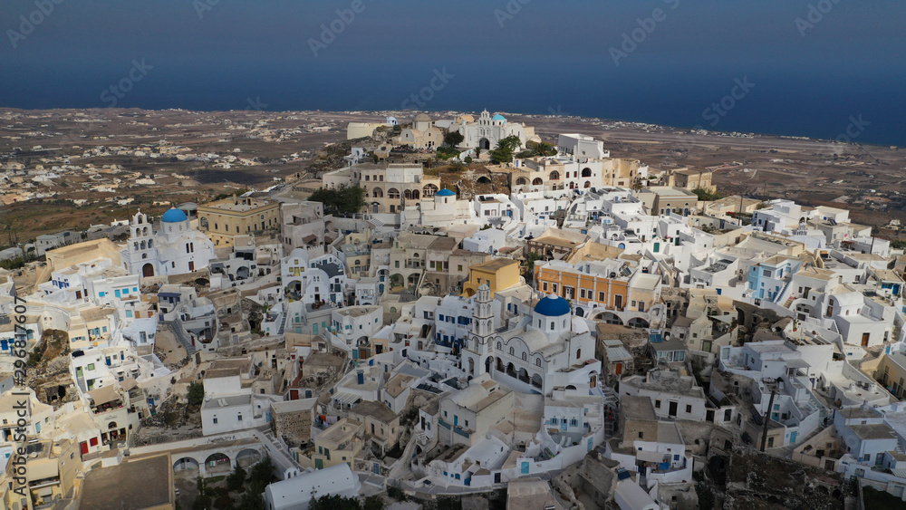 Aerial drone photo of iconic small traditional village and uphill castle of Pyrgos with great views to Santorini island Cladera, Cyclades, Greece Aerial drone photo of iconic small traditional village and uphill castle of Pyrgos with great views to Santorini island Cladera, Cyclades, Greece