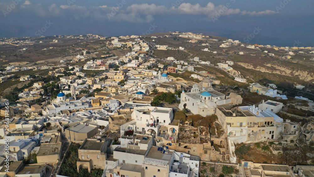 Aerial drone photo of iconic small traditional village and uphill castle of Pyrgos with great views to Santorini island Cladera, Cyclades, Greece