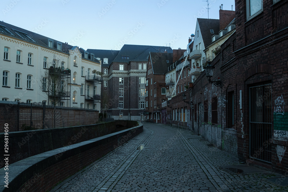 panoramic view of the evening city street with low old houses, Dusseldorf, Germany, December 10, 2018