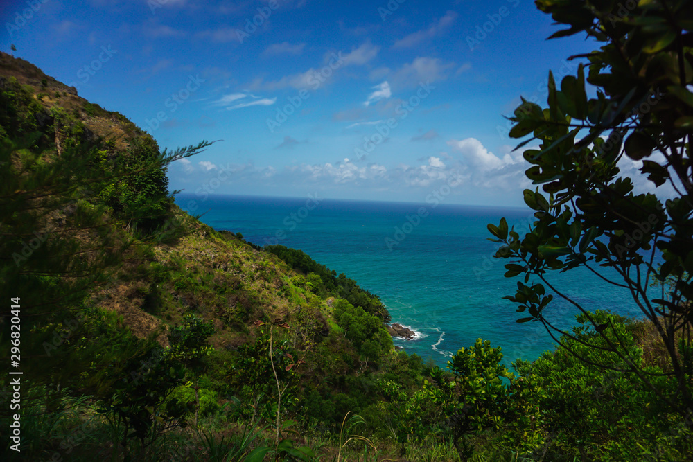 Tropical landscape with steep hill and ocean in the background. Kebumen, Central Java, Indonesia