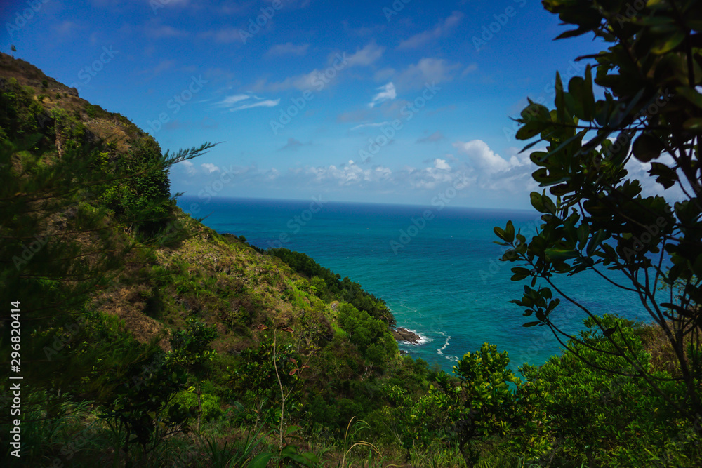 Tropical landscape with steep hill and ocean in the background. Kebumen, Central Java, Indonesia Tropical landscape with steep hill and ocean in the background. Kebumen, Central Java, Indonesia