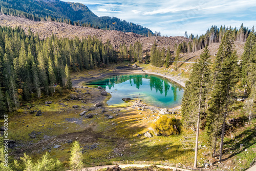 Aerial View of a small alpine Lake Carezza o Karersee located in the Dolomitesin, Italy