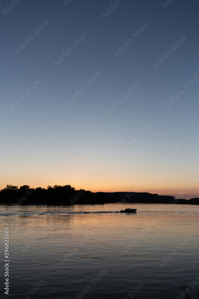 Boat on mississippi river during sunset in la crosse wisconsin