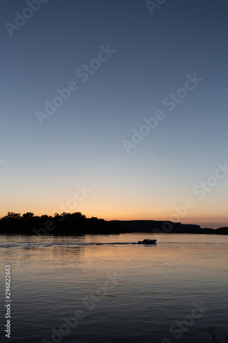 Boat on mississippi river during sunset in la crosse wisconsin