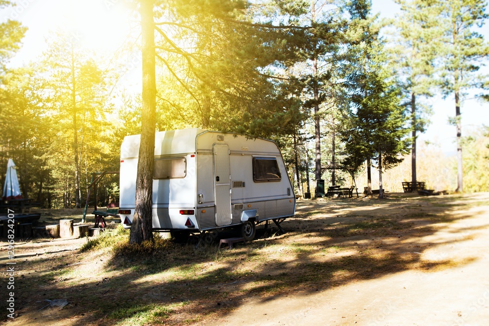 Campsite . Caravan car parking with old style vans. Family vacation travel, holiday trip in motorhome . Caravan trailer on a green lawn at the camping Campsite . Caravan car parking with old style vans. Family vacation travel, holiday trip in motorhome . Caravan trailer on a green lawn at the camping