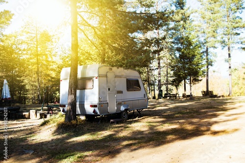 Campsite . Caravan car parking with old style vans. Family vacation travel, holiday trip in motorhome . Caravan trailer on a green lawn at the camping