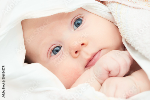 newborn little baby in white clothing