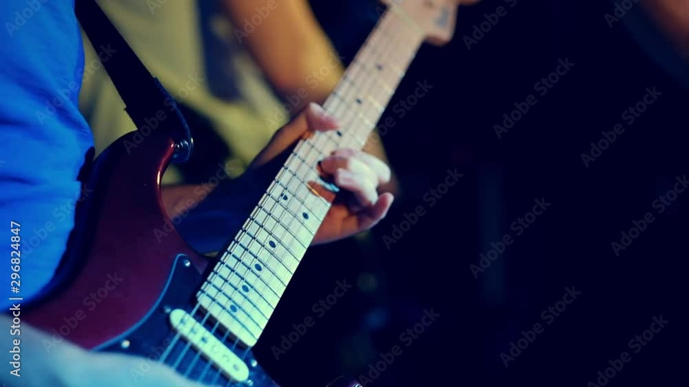 guitar player playing ona the guiter on the stage, close up