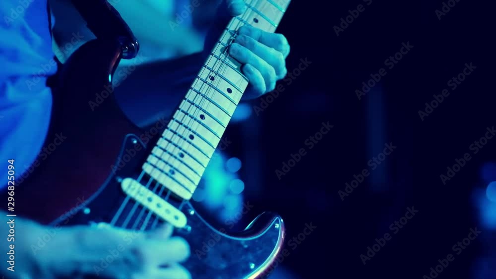 guitar player playing ona the guiter on the stage, close up