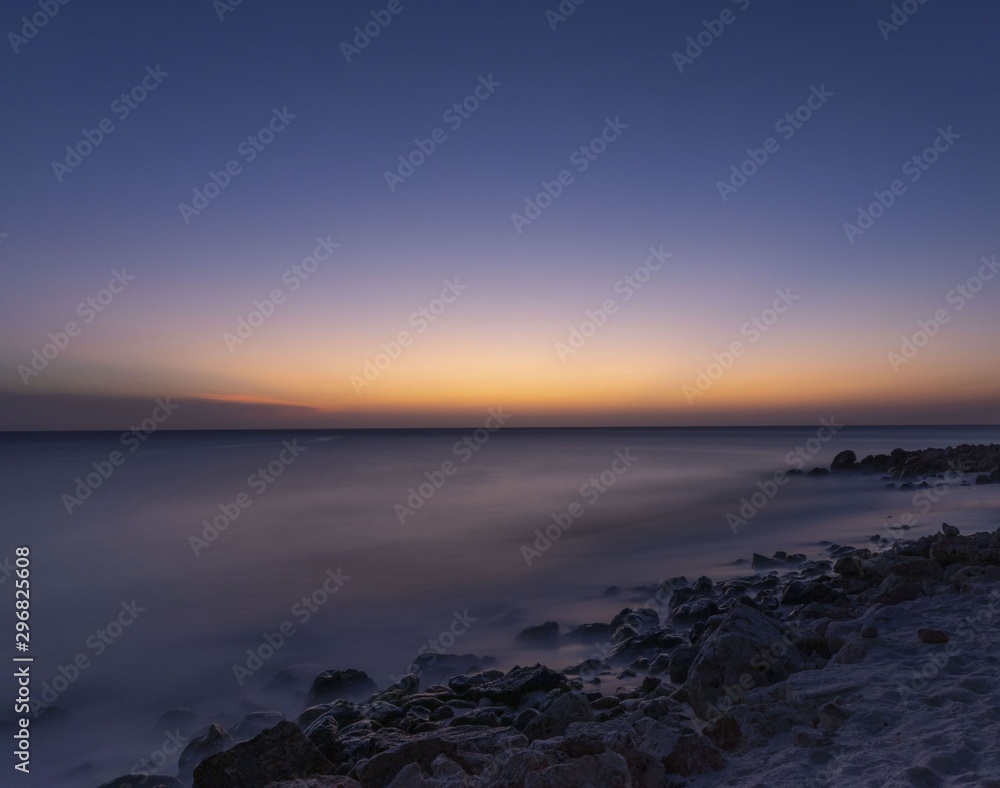 Gorgeous colorful view of sunset on Aruba. Beautiful nature landscape. Rocky coast of Atlanta, Caribbean.