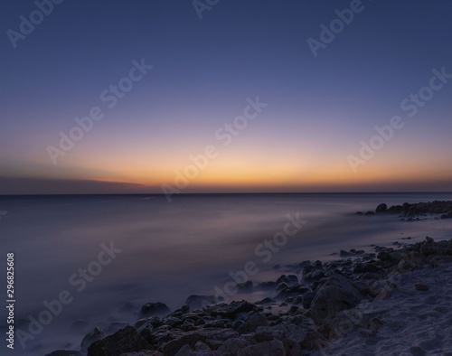 Gorgeous colorful view of sunset on Aruba. Beautiful nature landscape. Rocky coast of Atlanta, Caribbean.