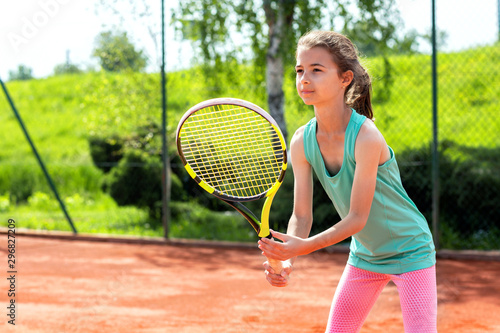 Sweet little girl holding a tennis racket © didesign