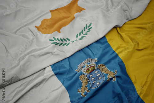 waving colorful flag of canary islands and national flag of cyprus.