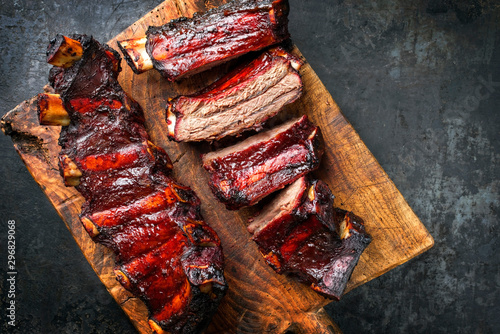Obraz na plátně Barbecue chuck beef ribs with hot marinade as top on a wooden cutting board with