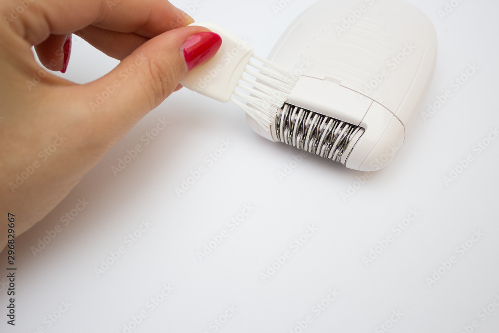 Set of means for epilation. Removal of unwanted hair. The process of  cleaning the epilator after use Stock Photo | Adobe Stock