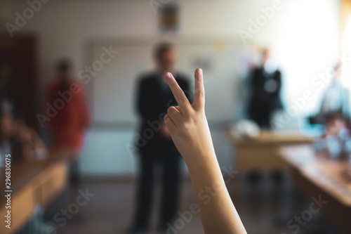 Wallpaper Mural Shallow depth of field image with a pupil raised hand to answer or put a question or to volunteer for a task in the classroom. Torontodigital.ca
