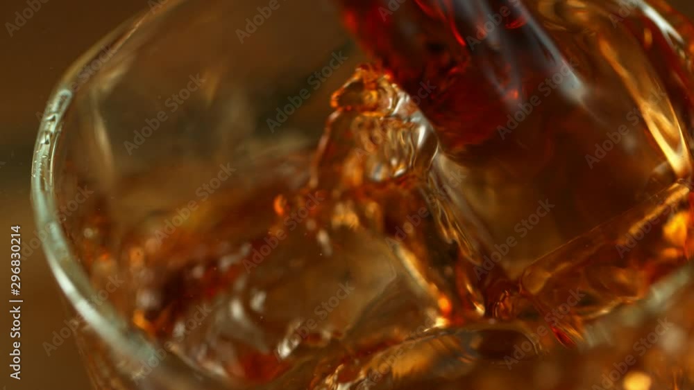 Super slow motion of pouring cola or alcohol drink into glass, super macro shot. Filmed on high speed cinema camera, 1000fps Super slow motion of pouring cola or alcohol drink into glass, super macro shot. Filmed on high speed cinema camera, 1000fps