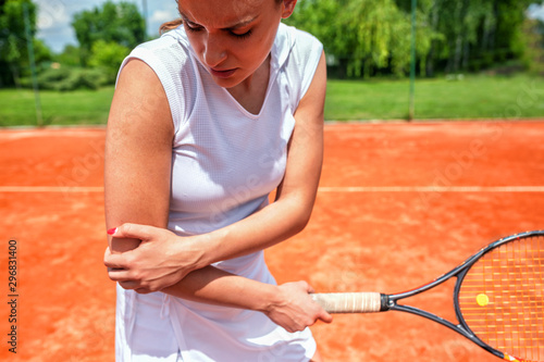 Elbow injury in tennis, unpleasant facial expression photo