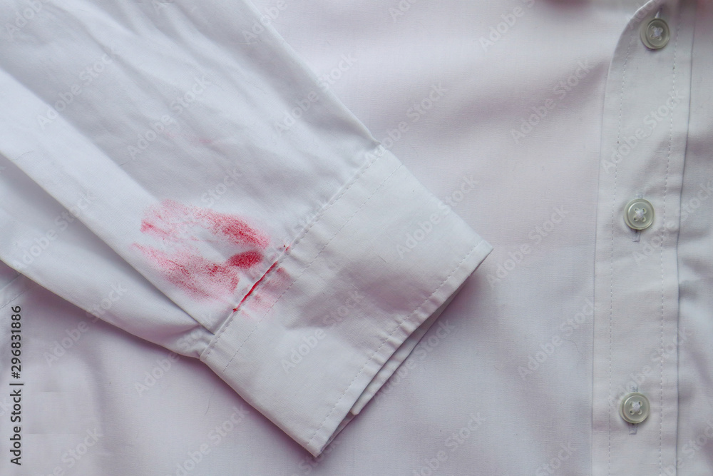 Dirty lipstick stain on white shirt. Stain remover concept