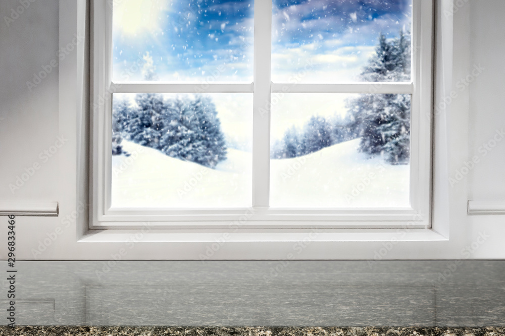 Obraz premium Winter decorations in bright colors with blurred snowy white and silver winter outside the window background.