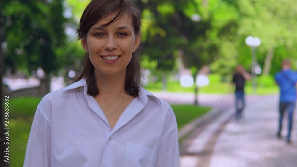 close up portrait caucasian woman in park girl looking camera on the background green nature close up portrait caucasian woman in park girl looking camera on the background green nature