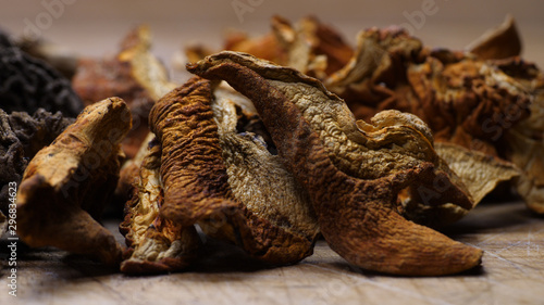 A closeup collection of dried mushrooms on a cutting board