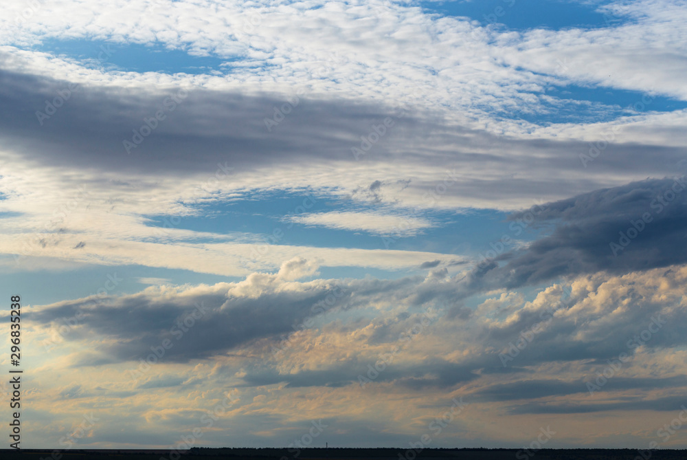 Clouds covered the sunset. Cirrus cloudscape on blue sky. The terrain in southern Europe. Fantastic skies on the planet earth. Tragic gloomy sky.