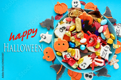 Fototapeta Naklejka Na Ścianę i Meble -  Halloween holiday card - candy bowl with candy and halloween cookies Trick or Treat	 