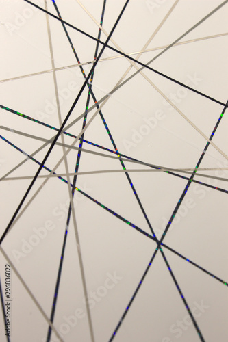 This is a photograph of a geometric design created using black,grey tape applied onto a White paper