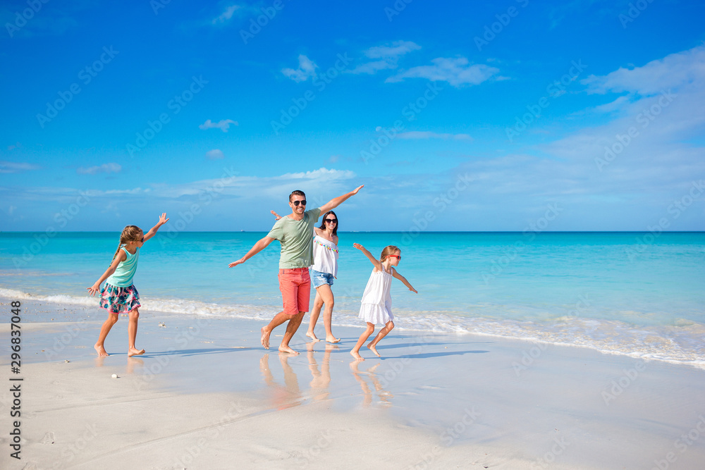 Happy family on the beach during summer vacation
