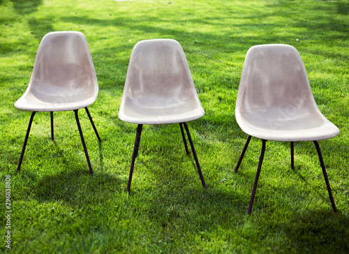 authentic herman miller eames chairs in grassy front yard photo