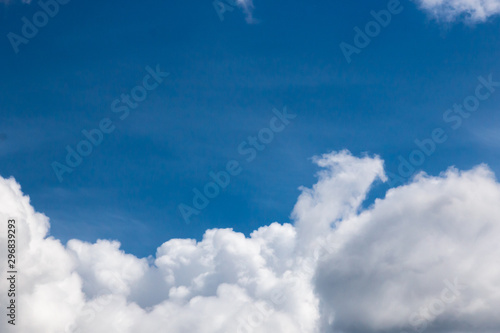 cumulus and high-cumulus clouds of an average tier on blue heavenly space