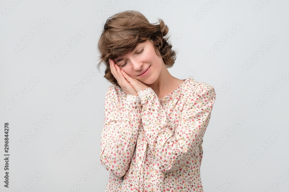 Young woman with her eyes closed having positive thoughts. Studio shot. Young woman with her eyes closed having positive thoughts. Studio shot.