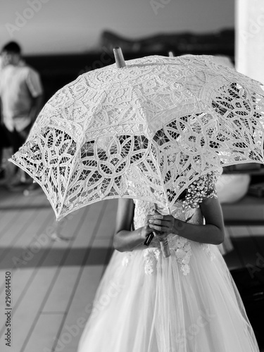 Woman in white dress holding umbrella