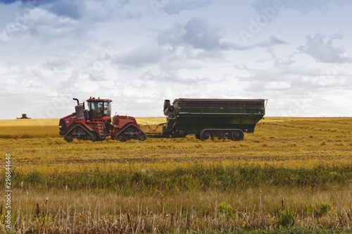 Farm tractor and grain cart photo
